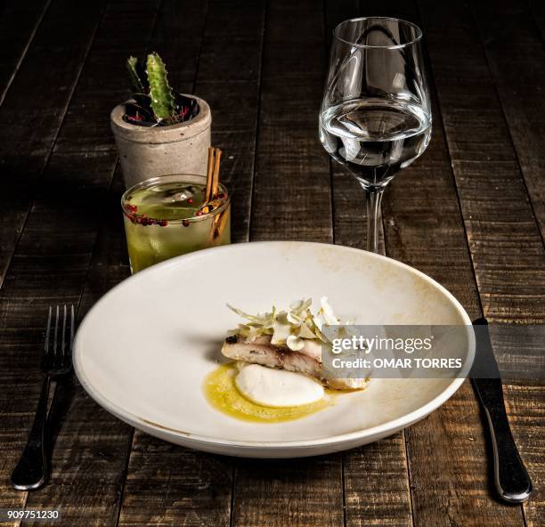 Dish of white fish poached in olive oil with creamy rice, Cotija cheese and cauliflower is pictured at Mexican chef Fernando Martinez's restaurant...