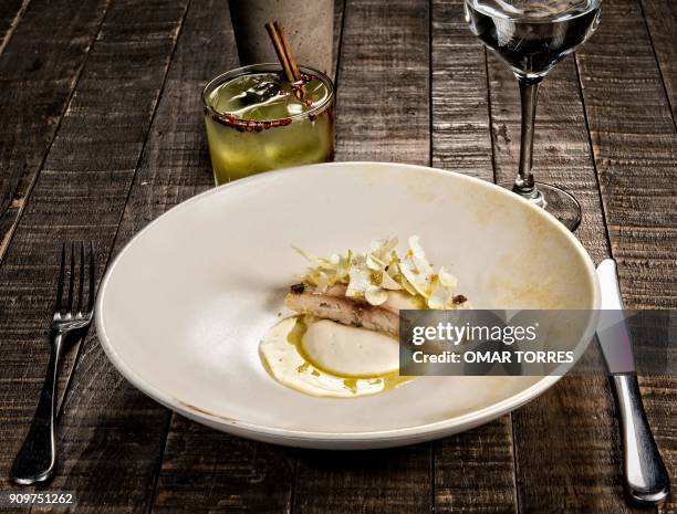 Dish of white fish poached in olive oil with creamy rice, Cotija cheese and cauliflower is pictured at Mexican chef Fernando Martinez's restaurant...