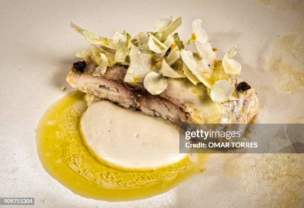 Dish of white fish poached in olive oil with creamy rice, Cotija cheese and cauliflower is pictured at Mexican chef Fernando Martinez's restaurant...