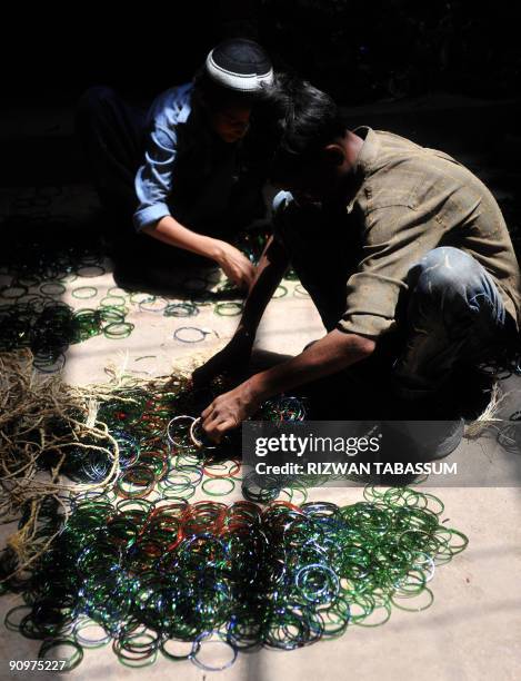 Pakistan-religion-economy-Eid BY HASAN MANSOOR This picture taken on September 2, 2009 shows Pakistani boys sorting through bangles at a workshop in...