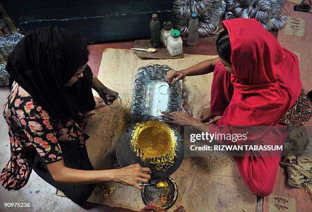 Pakistan-religion-economy-Eid BY HASAN MANSOOR This picture taken on September 2, 2009 shows Pakistani girls shining bangles at a house in Hyderabad,...