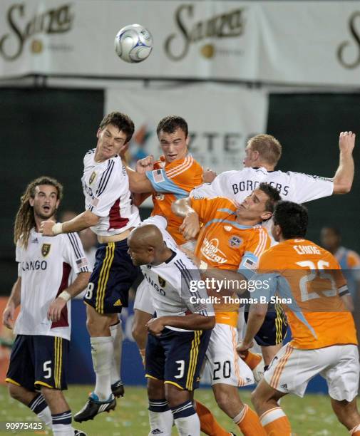 Cam Weaver of the Houston Dynamo and teammates tries to head the ball against Will Johnson and teammates of Real Salt Lake at Robertson Stadium on...