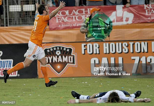 Brad Davis of the Houston Dynamo celebrates his 20 yard goal while Kyle Beckerman of Real Salt Lake lies on the pitch at Robertson Stadium on...