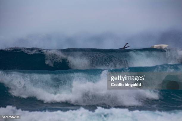 surfer jumping over the big waves - indonesia surfing stock pictures, royalty-free photos & images