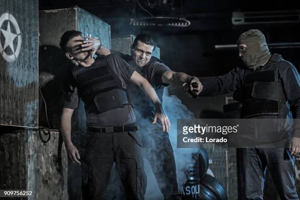 krav maga fighting group training in witness protection in dark indoor urban setting - committee of public security and fight stock pictures, royalty-free photos & images
