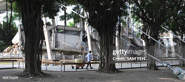 Taiwan-quake-10years BY AMBER WANG In this picture taken on September 17 a worker cleans in front of a school damaged in an earthquake ten years ago,...