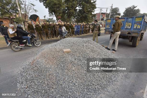 The pile of gravel dumped on road in order to block the traffic near village Bhondsi in Gurgaon allegedly by activists of Karni Sena, who were...