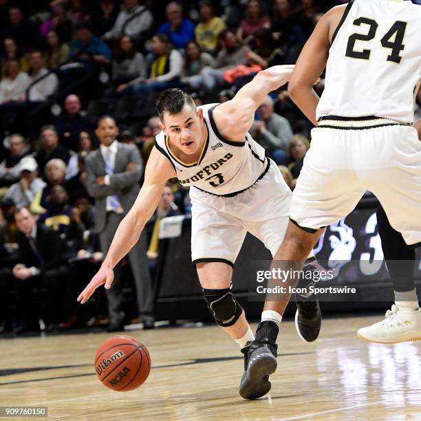 Fletcher Magee guard Wofford College Terriers makes a break on the pick against the University of Tennessee Chattanooga Moc for this rebound,...