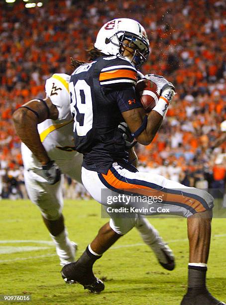 Darvin Adams of the Auburn Tigers scores a touchdown as he gets tackled by Robert Sands of the West Virginia Mountaineers at Jordan-Hare Stadium on...