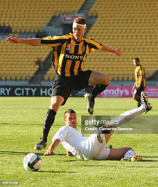 Tony Lochhead of the Phoenix avoids the tackle of John Tambouras of Fury FC during the round seven A-League match between the Wellington Phoneix and...