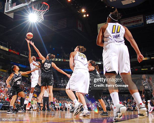DeWanna Bonner of the Phoenix Mercury shoots against Ruth Riley of the San Antonio Silver Stars in Game Two of the WNBA Western Conference Semifinals...