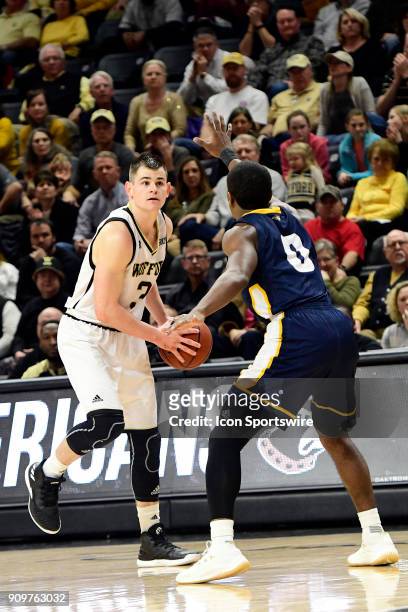 Fletcher Magee guard Wofford College Terriers fakes a break before setting to loft a three-pointer against the University of Tennessee Chattanooga...
