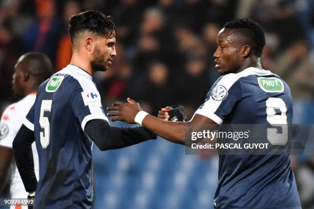 Montpellier's Chadian forward Casimir Ninga is congratulated by his teammate Montpellier's Portuguese defender Pedro Mendes after scoring a goal...