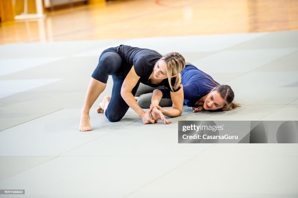 Young Adult Women at Selfdefence Course with Judo Trainer