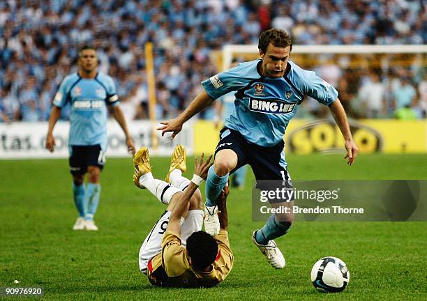 Adam Casey of Sydney avoids the challenge from Ali Abbas of the Jets during the round seven A-League match between Sydney FC and the Newcastle Jets...