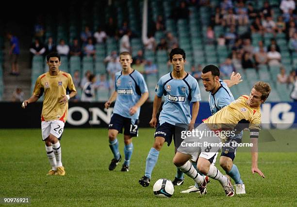 Matt Thompson of the Jets is pulled to the ground by the challenge of Mark Bridge of Sydney during the round seven A-League match between Sydney FC...