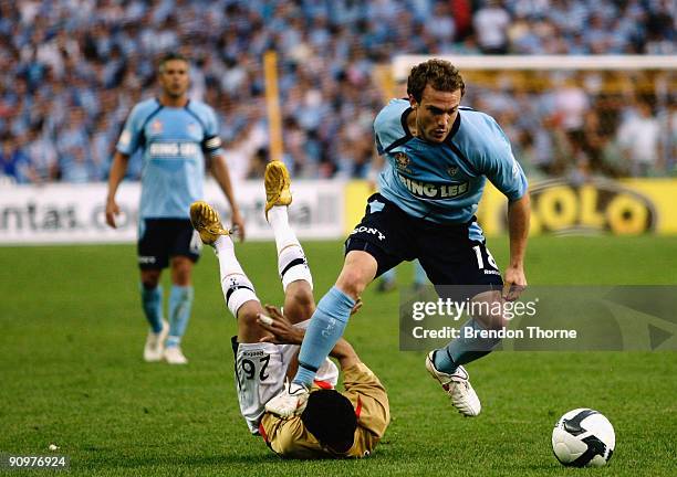 Adam Casey of Sydney avoids the challenge from Ali Abbas of the Jets during the round seven A-League match between Sydney FC and the Newcastle Jets...