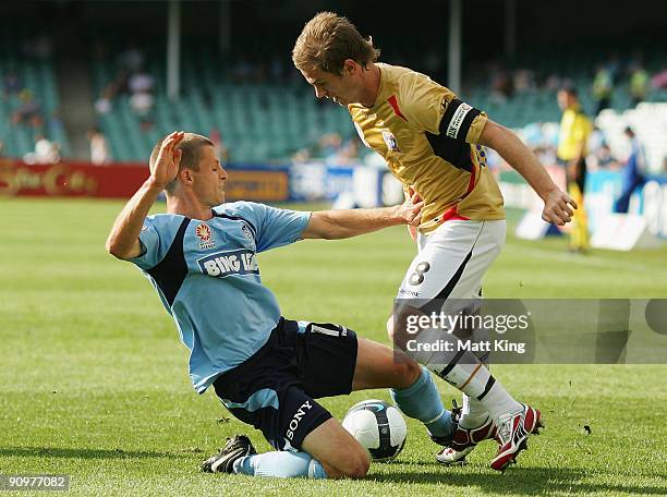 Shannon Cole of Sydney puts a challenge on Matthew Thompson of the Jets during the round seven A-League match between Sydney FC and the Newcastle...