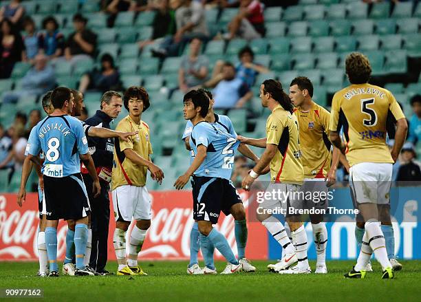 Sung-Hwan Byun of Sydney is restrained by Jets players after a late tackle from Tarek Elrich of the Jets which resulted in a red card during the...