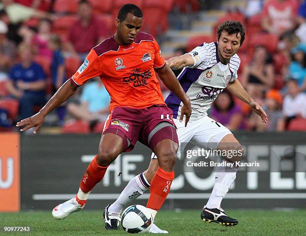 Reinaldo of the Roar is pressured by the defence during the round seven A-League match between the Brisbane Roar and Perth Glory at Suncorp Stadium...