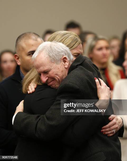 Michigan State University Police Chief Jim Dunlap hugs Asst. Michigan Attorney General Angela M. Povilaitis after former Michigan State University...