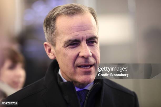 Mark Carney, governor of the Bank of England, speaks to an attendee between sessions on day two of the World Economic Forum in Davos, Switzerland, on...