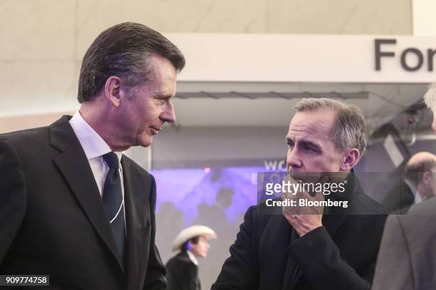Philipp Hildebrand, vice chairman of Blackrock Inc., left, speaks with Mark Carney, governor of the Bank of England, between sessions on day two of...