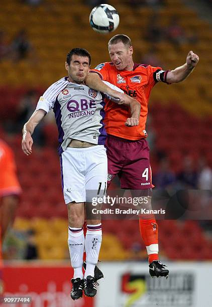 Craig Moore of the Roar and Branko Jelic of the Glory challenge for the ball during the round seven A-League match between the Brisbane Roar and...
