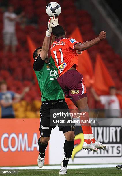 Goalkeeper Aleks Vrteski of the Glory is challenged by Reinaldo of the Roar during the round seven A-League match between the Brisbane Roar and Perth...