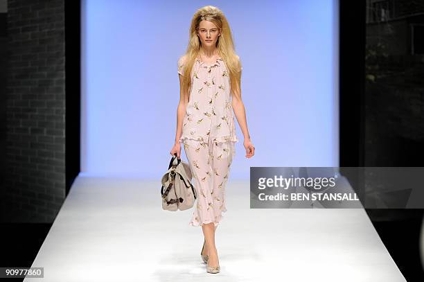 Model displays an outfit by designer Betty Jackson during Spring/Summer 2010 collection show on the third day of the London Fashion Week, in central...