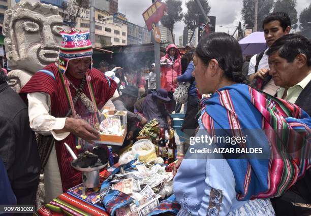 Yatari makes a ritual during the inauguuration of the Alasitas Fair in La Paz on January 24, 2018. In this and other Andean cities in Bolivia, Peru...