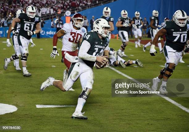 Michigan State Spartans quarterback Brian Lewerke scrambles with the ball and heads towards the end zone in the second half of the Holiday Bowl...