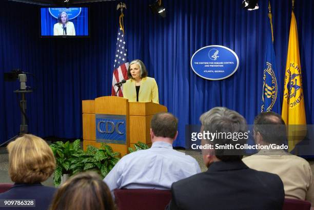 Photograph of Julie Gerberding, former CDC director, speaking in front of a group of reporters at an official press conference, addressing hurricane...