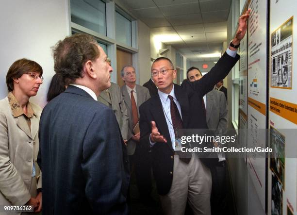 Photograph of Dr Keiji Fukuda, an epidemiologist and EIS officer, discussing the implications of an influenza pandemic with Senator Arlen Specter...