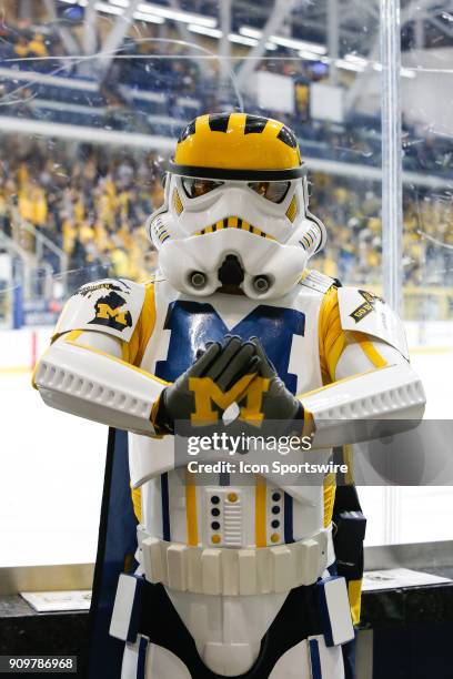Fan dressed in a Michigan-themed Star Wars Stormtropper costume poses for photographs during a regular season Big 10 Conference hockey game between...