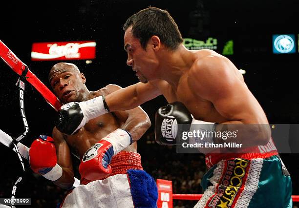 Juan Manuel Marquez throws a punch at Floyd Mayweather Jr. During their fight at the MGM Grand Garden Arena September 19, 2009 in Las Vegas, Nevada....