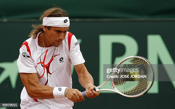 Spain's David Ferrer returns the ball against Israeli Andy Ram during the fourth match of the Davis cup semifinal between Spain and Israel at the...