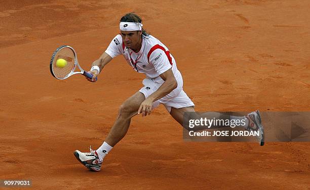 Spain's David Ferrer returns the ball against Israeli Andy Ram during the fourth match of the Davis cup semifinal between Spain and Israel at the...