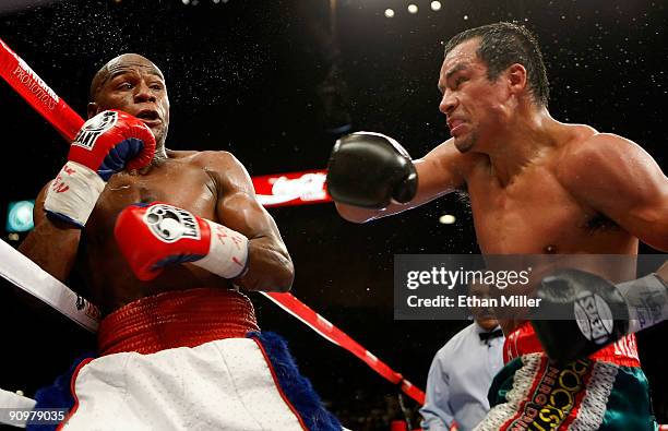 Floyd Mayweather Jr. And Juan Manuel Marquez exchange blows in the fourth round of their fight at the MGM Grand Garden Arena September 19, 2009 in...