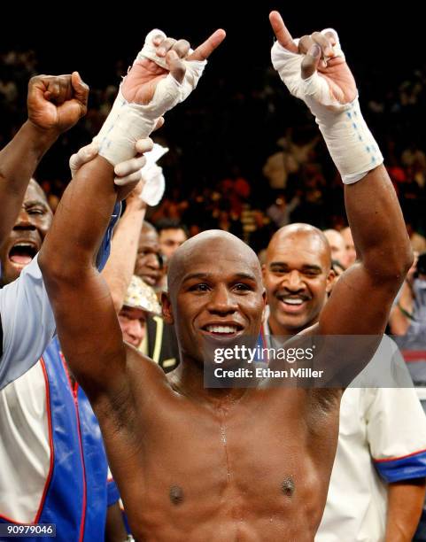 Floyd Mayweather Jr., with his advisor Leonard Ellerbe behind him, celebrates his unanimous-decision victory over Juan Manuel Marquez at the MGM...