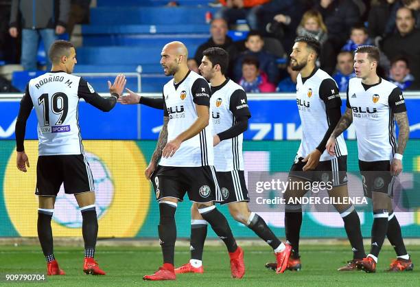 Valencia players celebrate a goal by Spanish forward Santiago Mina Lorenzo during the Spanish 'Copa del Rey' quarter-final second leg football match...