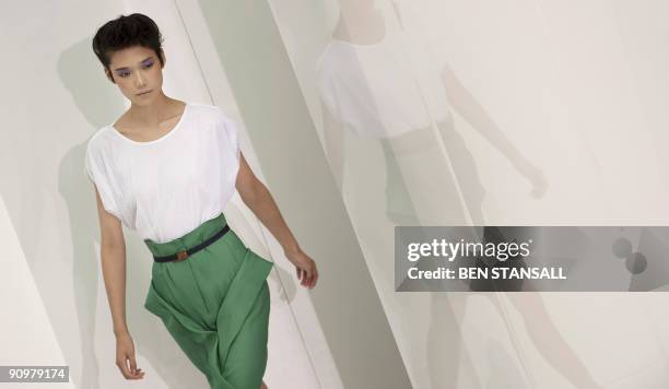 Model displays an outfits by designer Nicole Farhi during Spring/Summer 2010 collection show on the third day of the London Fashion Week, in central...