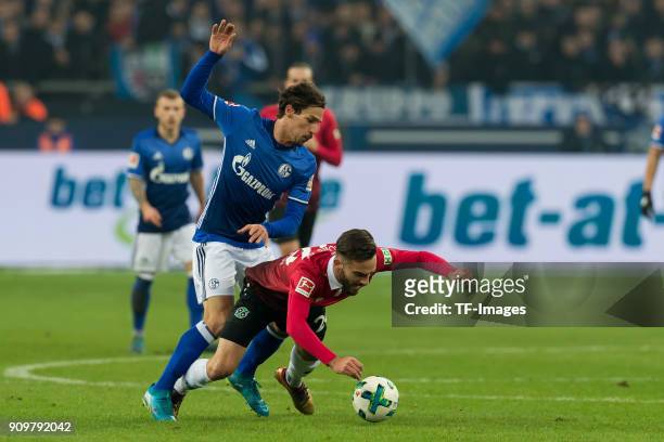 Benjamin Stambouli of Schalke and Kenan Karaman of Hannover battle for the ball during the Bundesliga match between FC Schalke 04 and Hannover 96 at...