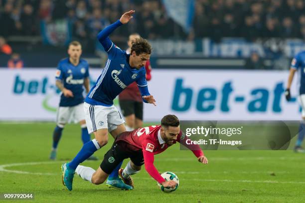 Benjamin Stambouli of Schalke and Kenan Karaman of Hannover battle for the ball during the Bundesliga match between FC Schalke 04 and Hannover 96 at...