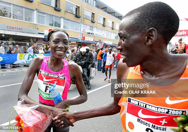 Moses Masai and his sister Linet Masai from Kenya shake hands after winning the 25th 'Dam tot Damloop' race on September 20, 2009 in Zaandam, the...