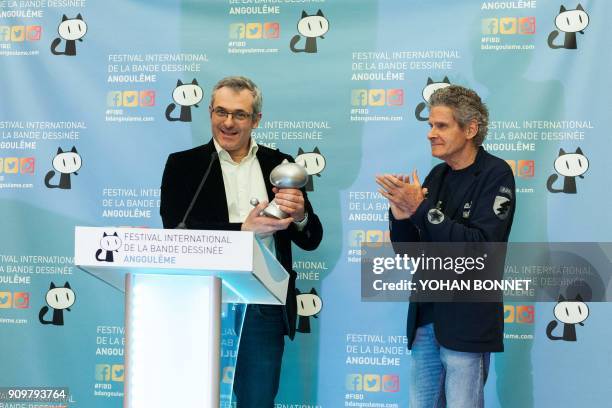 French publisher Laurent Lerner representatively accepts the Lifetime Achievement award from the city of Angouleme for US cartoonist Richard Corben...