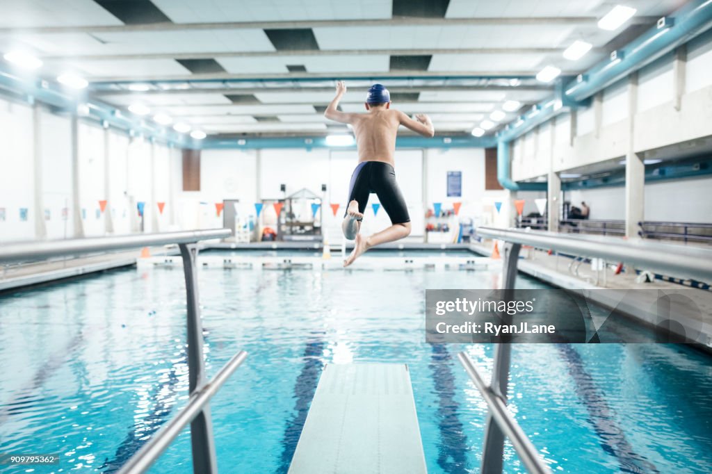 Boy In Pool on Diving Board