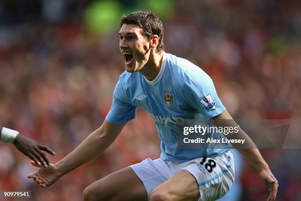 Gareth Barry of Manchester City celebrates scoring his team's first goal during the Barclays Premier League match between Manchester United and...