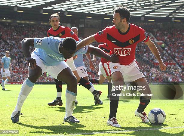 Ryan Giggs of Manchester United clashes with Micah Richards of Manchester City during the FA Barclays Premier League match between Manchester United...