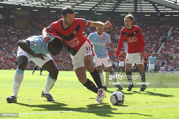 Ryan Giggs of Manchester United clashes with Micah Richards of Manchester City during the FA Barclays Premier League match between Manchester United...